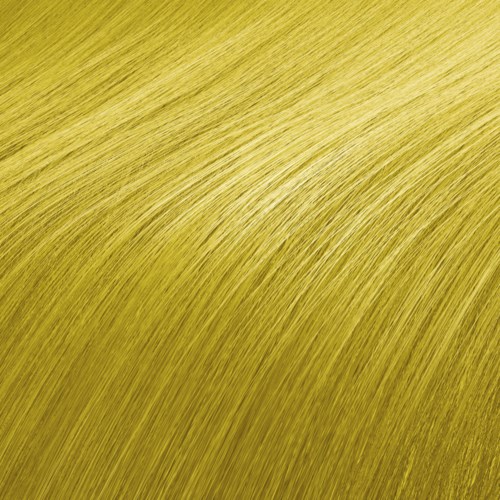 Nahaufnahme eines gelblich-grünen Grasfeldes mit sanften Kurven und feinen Grashalmen. Das Sonnenlicht verstärkt die Farbe und Textur.