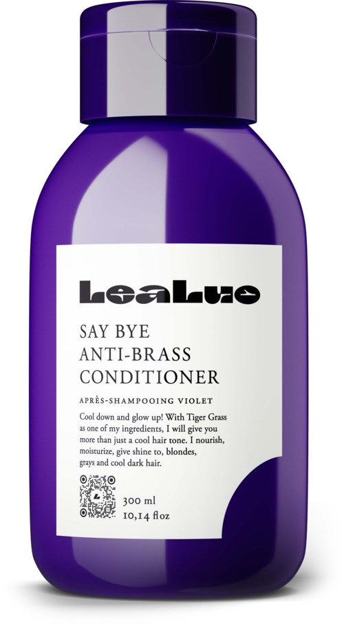 En lilla flaske anti-brass balsam for hår. Den har en hvit etikett med svart og lilla tekst.