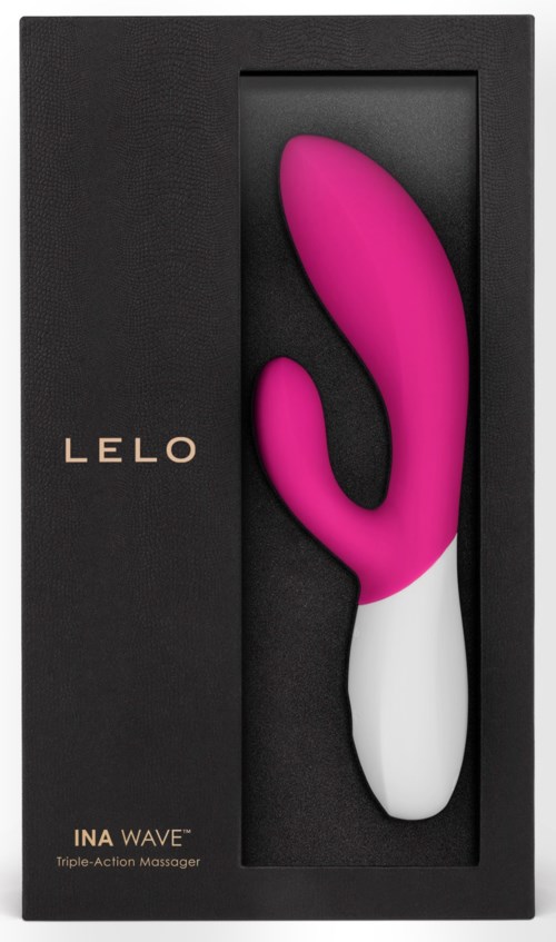 En rosa och vit formad leksak i ett svart lock märkt LELO INA WAVE, en trefunktionell massör.