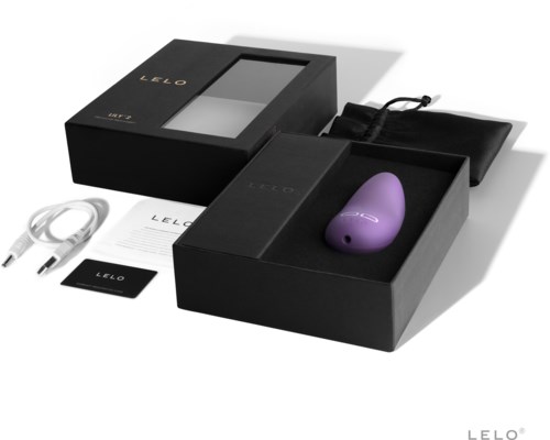 A box with a purple device, charger, cables, and manuals inside, likely a product setup kit.