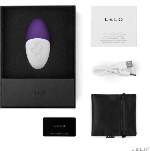 A purple and white device, USB cable, black pouch, warranty card, and instruction sheet arranged neatly.