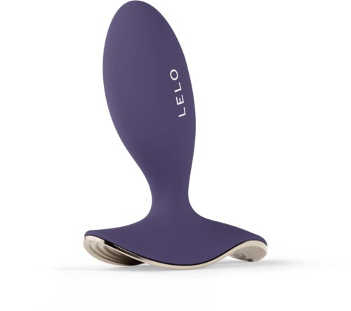 A purple shoe-shaped object with the word LELO on it, made of smooth material, curves with a flat bottom.