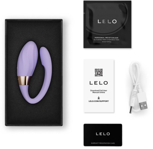 Lilla lilla vibrator med gullfarge i en svart eske, inkluderer lader, brukerhåndbok og garantikort.