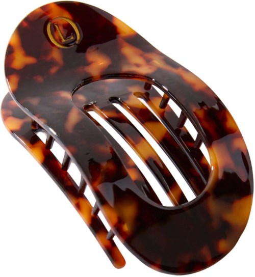 A tortoise shell-patterned plastic hair clip with a gold logo and slotted middle part.