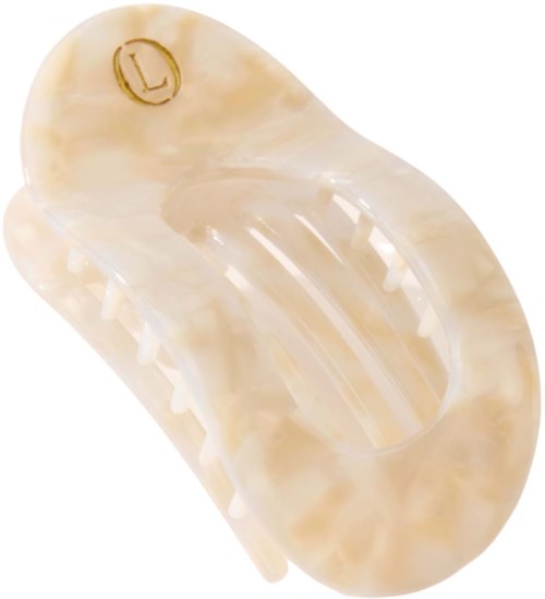 A beige plastic hair clip with a gold letter L engraved on it.