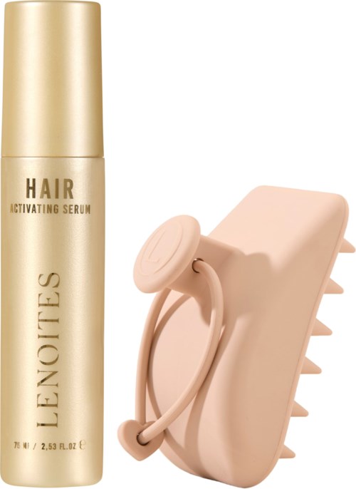 A gold bottle of hair serum and a pink hairbrush with wide teeth.
