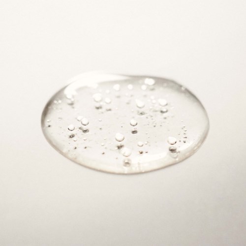 Clear gel with small bubbles on a plain background.