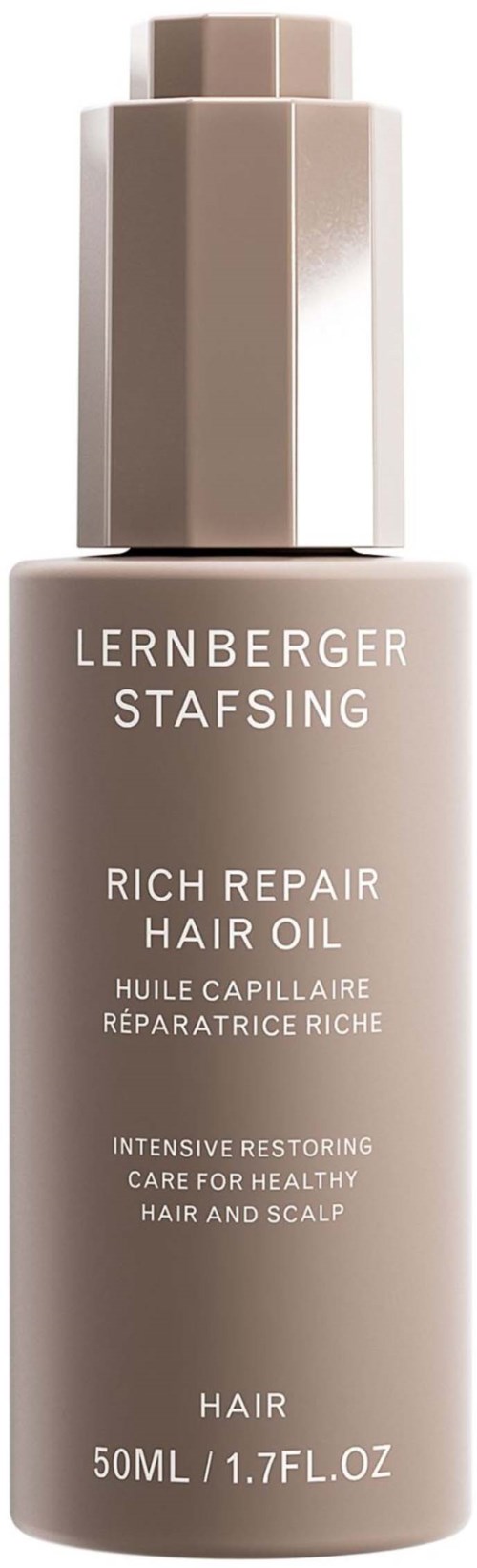 A bottle of hair repair oil with a pump, labeled in English, for nourishing hair and scalp. It contains 50ml.