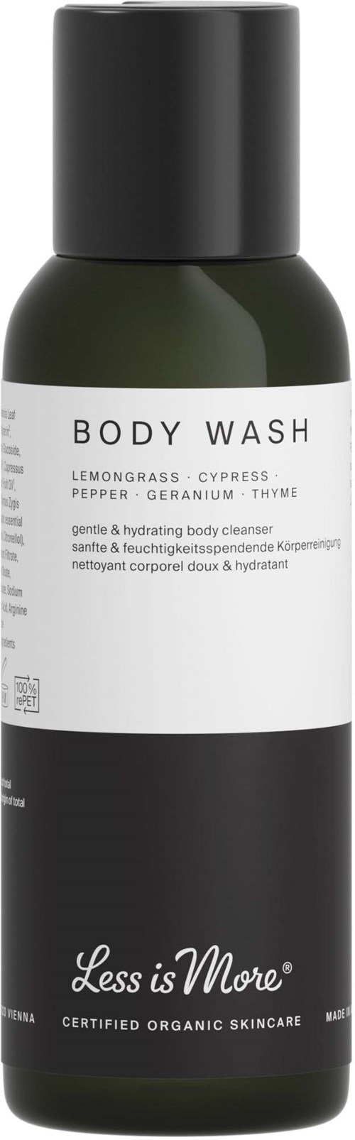 En flaske body wash med sort, hvid og grøn farve, mærket med duftnoter og mærkenavnet Less is More.