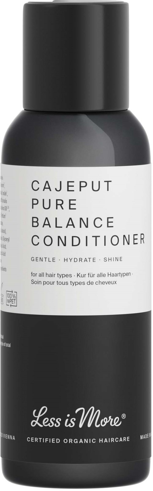 En sort og hvid flaske med balsam med teksten 'CAJEPUT PURE BALANCE CONDITIONER' og 'Less is More'.