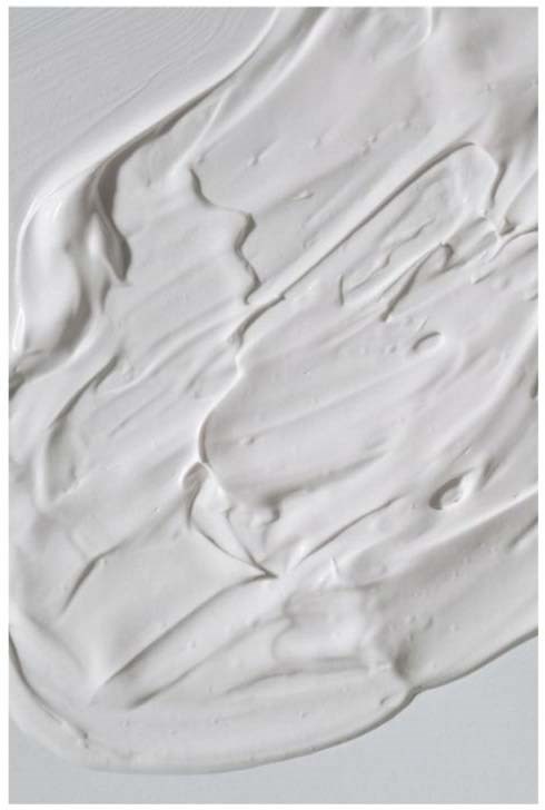 White cream spread with smooth, textured strokes. Likely a cosmetic or food product. No other elements visible.