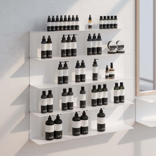 A white wall shelf holds various bottles, some with droppers, and two small round containers for products.
