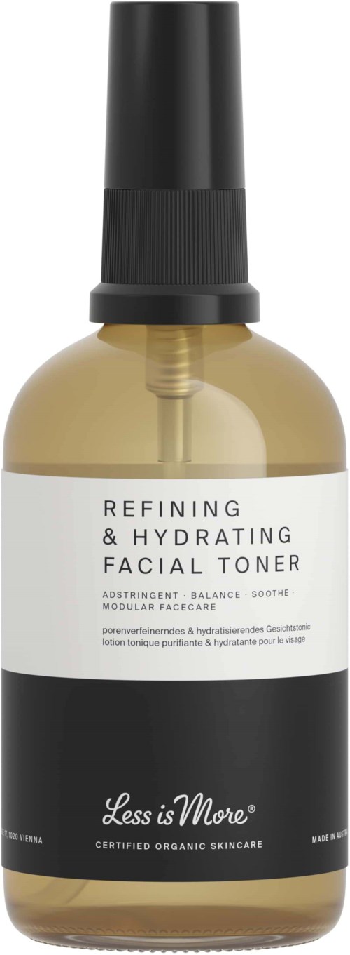 En ansiktsvannflaske merket 'Refining & Hydrating Facial Toner' med spraymunnstykke, i svart og klart design.