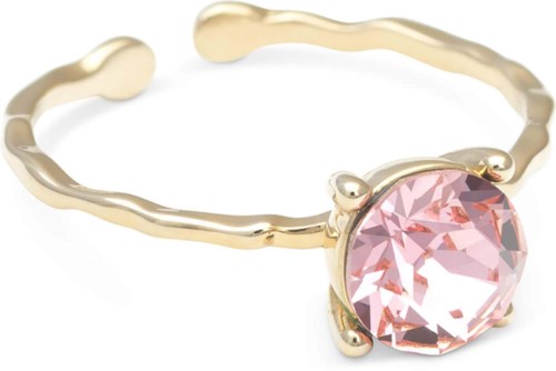 A gold ring with a pink gemstone in the center, having a wavy band design.