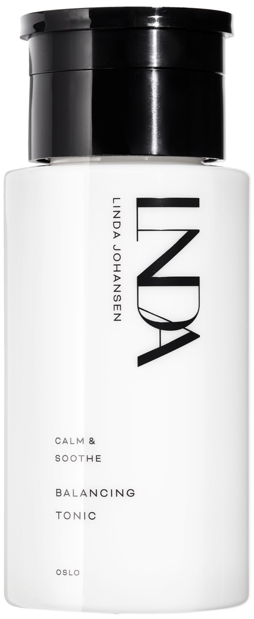 Hvit flaske med svart lokk, merket "LINDА JOHANSEN" og "BALANCING TONIC," med enkel tekst og design.