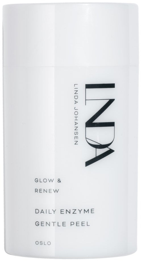En hvit sylinderformet flaske med svart tekst, merket INDY, Daily Enzyme Gentle Peel, Oslo, og ord som Glow & Renew.