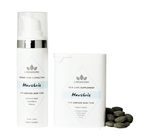 Hudvårdsprodukter med pumpflaska och en box, plus svarta tabletter, för att korrigera ojämn hudton.