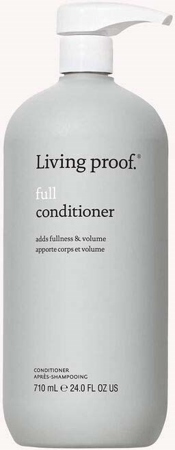 A white bottle of Living proof full conditioner with a pump, labeled for hair volume and fullness.