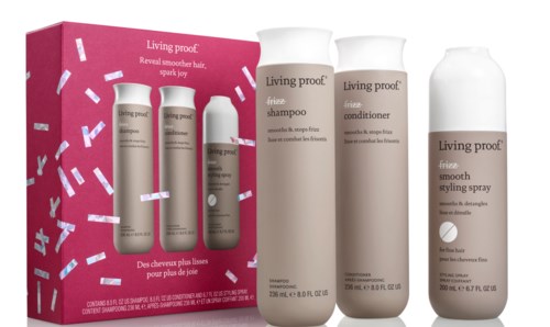 A hair care set with shampoo, conditioner, and styling spray in bottles; pink box with confetti design.