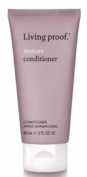 Pink tubflaska märkt 'Living proof' restore balsam, 60 mL, med svart text.