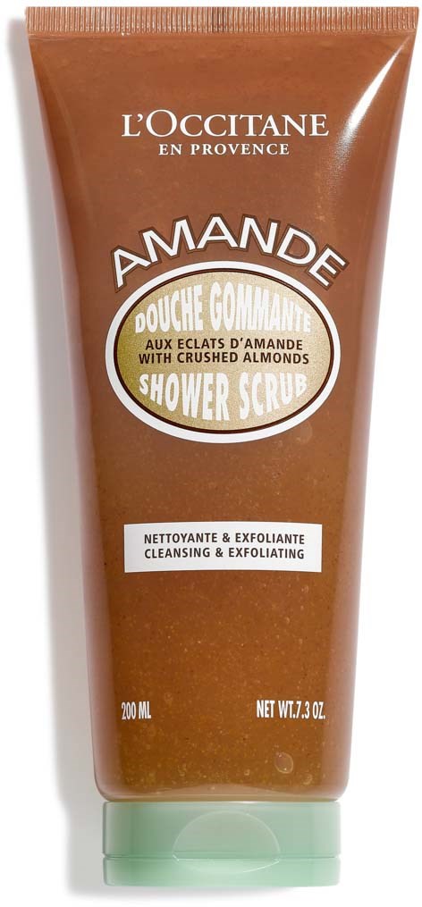 En brunt duschskrubbtub med vita och gula etiketter, innehållande mandelpeelingprodukt, 200 ml.