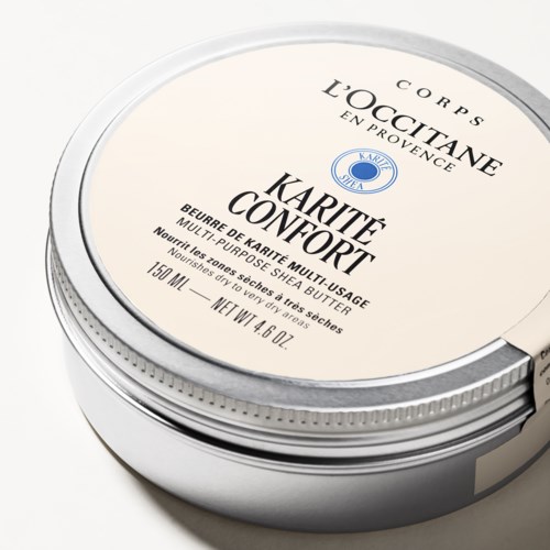 En rund behållare av L'Occitane kroppssmörj med beige lock och svart text, med en blå logga.