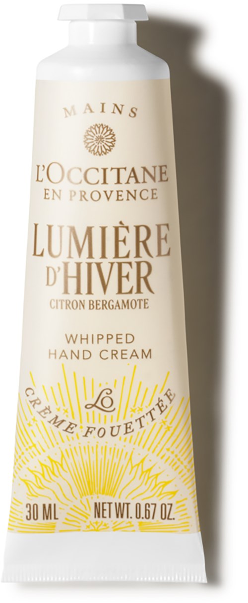 A white tube of hand cream with gold and yellow text, brand L'Occitane, titled 'Lumière d'Hiver'.