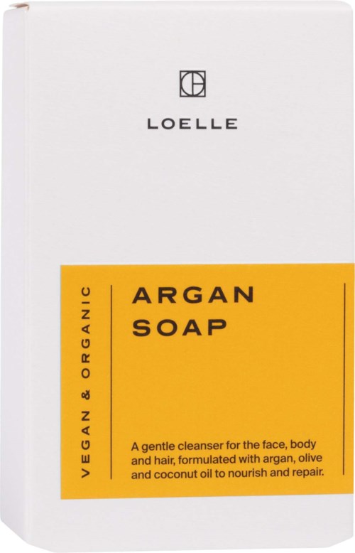 Eine weiße Seifenverpackung mit einem gelben Etikett, das 'Argan Soap' sagt und die sanften, nährenden Inhaltsstoffe beschreibt.