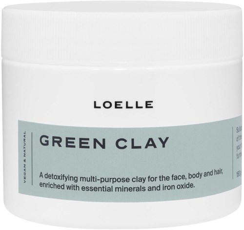 A white jar of Loelle green clay, used for face, hair, and body, enriched with minerals.