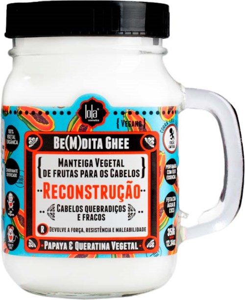A white jar with a black lid, labeled as vegan hair treatment made from fruit and vegetable extracts.