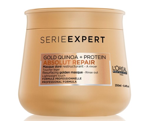 A beige jar with black and orange text, labeled as L'Oréal hair mask for damaged hair with quinoa and protein.