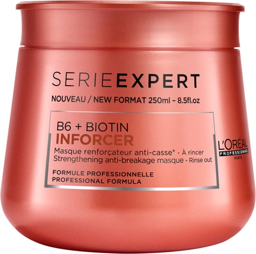 En rosa hårinpackningsbehållare med svart och vitt text för Loreal series expert B6 och Biotin infuser. Fräsch design.