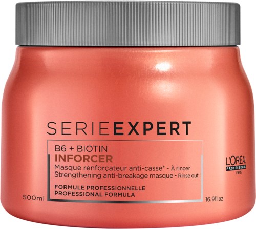 En persikfärgad burk med ett grått lock, märkt som stärkande och mot brott, av L'Oréal Professionnel.
