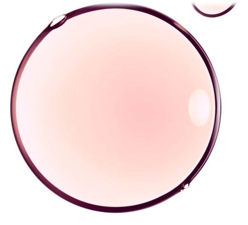 Et stort, rundt, rosaaktig glass med et mindre glass eller boble i nærheten, som reflekterer lys.