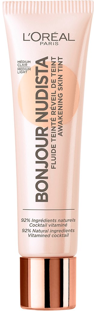 En tub med L'Oreal Bonjour Nudista hudtint med rosa färg och guldkapsel.