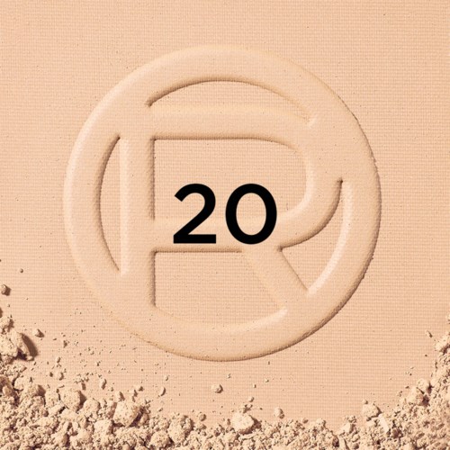 A round symbol with a stylized letter 'R' and the number 20 inside it on sandy ground.