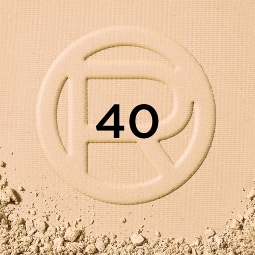 A white circular object with the number 40 in the center, partially buried in sand.