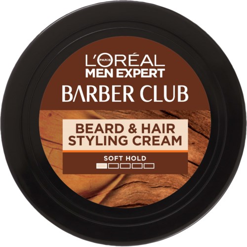 En rund behållare av L'Oréal Men Expert Beard & Hair Styling Cream med en brun etikett och träbakgrund.