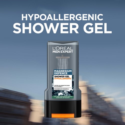 En grå flaska med L'Oréal Men Expert duschgel med blå och vit etikett, placerad mot en blå bakgrund.