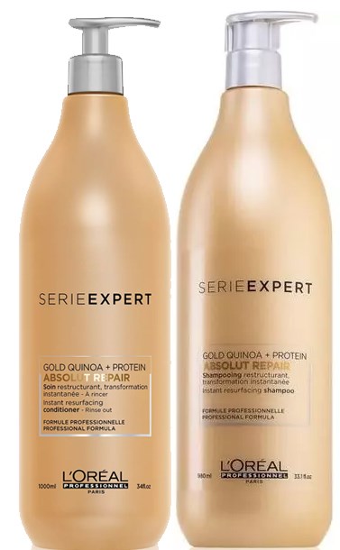 Two beige bottles with pump dispensers labeled 'Serie Expert' for hair care by L'Oréal, mentioning quinoa and protein.