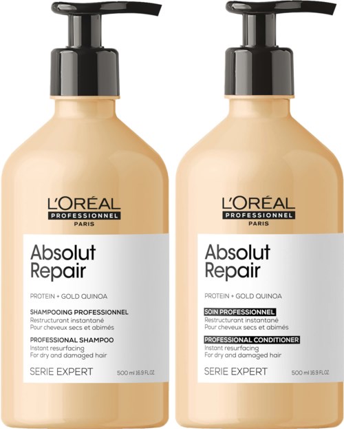 Två beige flaskor av L'Oréal-shampoo med svarta pumpkapslar, märkta 'Absolut Repair' för skadat hår, 500 ml vardera.
