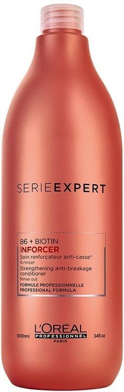 Różowa butelka odżywki wzmacniającej L'Oréal Professionnel Inforcer do włosów. Ma korek i informacje o produkcie na etykiecie.