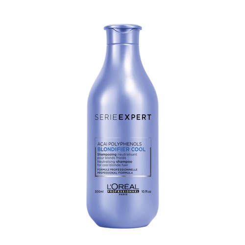 En blå schampoflaska märkt 'L'Oréal Professionnel' med ord om hårvård och professionella formuleringar.