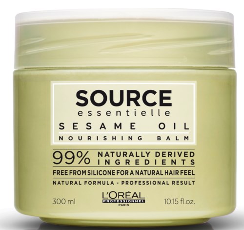 En grønn krukke med Source Essentielle Nourishing Balm som inneholder informasjon om ingredienser og fordeler.