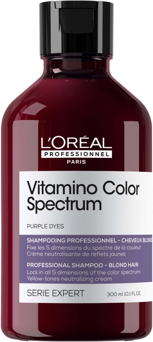 Een donkerpaarse shampoefles met een zwart deksel, bedoeld voor blond haar en kleurenspectrumverzorging.