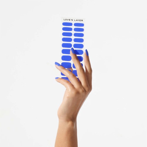 A hand holds a strip with blue layers and the words "LOVE N LAYER" at the top.