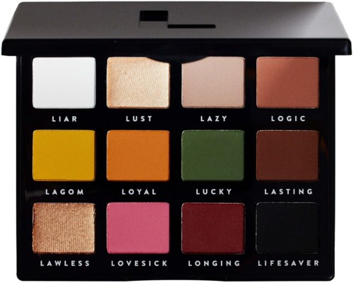 A 12-shade eyeshadow palette with names like 'Liar' and 'Lust', featuring various colors from white to black and bright shades.