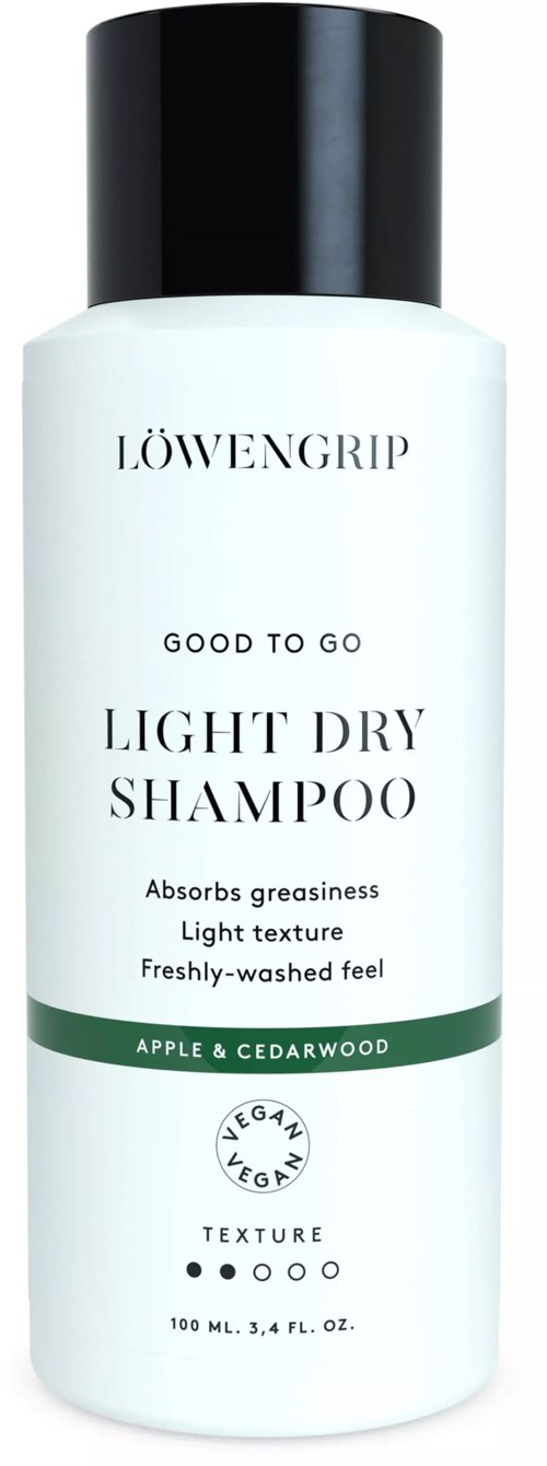 En hvid flaske med sort låg, mærket 'LÖWENGRIP' til let tørt shampoo med æble og cedertræduft.