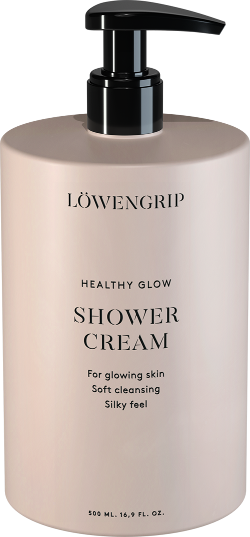Valkoinen pullo mustalla pumpulla, merkinnällä Löwengrip Healthy Glow Shower Cream, pehmeälle ja hehkuvalle iholle.