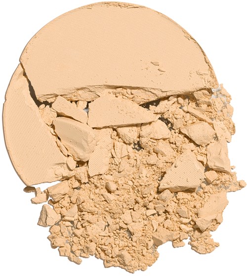 A beige powder with a large chunk and smaller pieces, all broken and spread out.